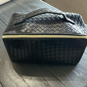 Black woven cosmetic travel bag